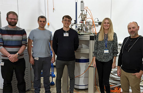 The Lancaster University team in the Apps Lab (from left to right Dr Michael Thompson, Prof. Jonathan Prance, and George Ridgard) with Abi Graham and Ben Yager from Oxford Instruments NanoScience.